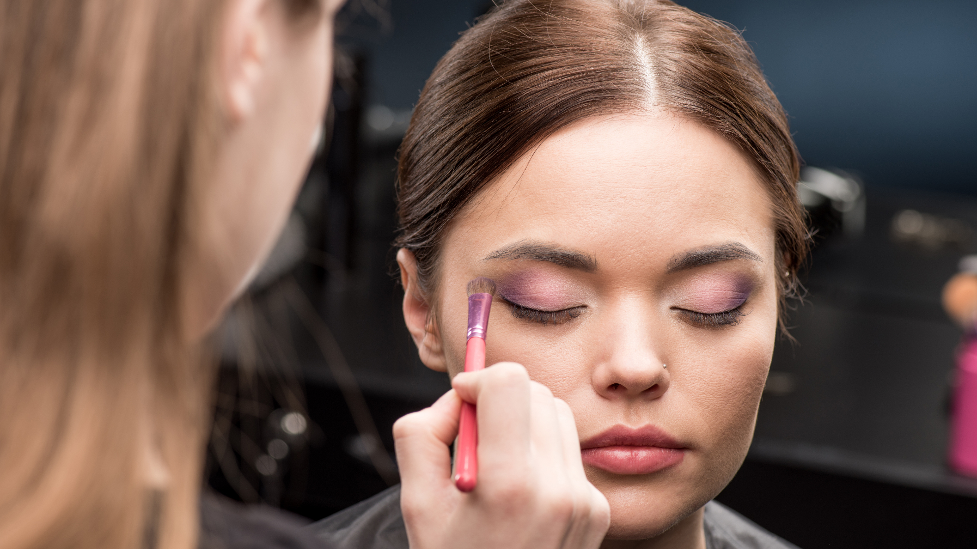 makeup artist applying eyeshadow