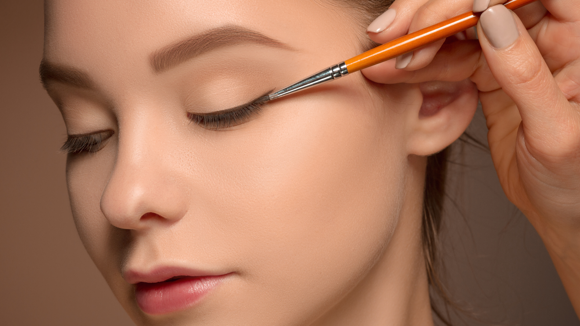 woman applying an eyeliner