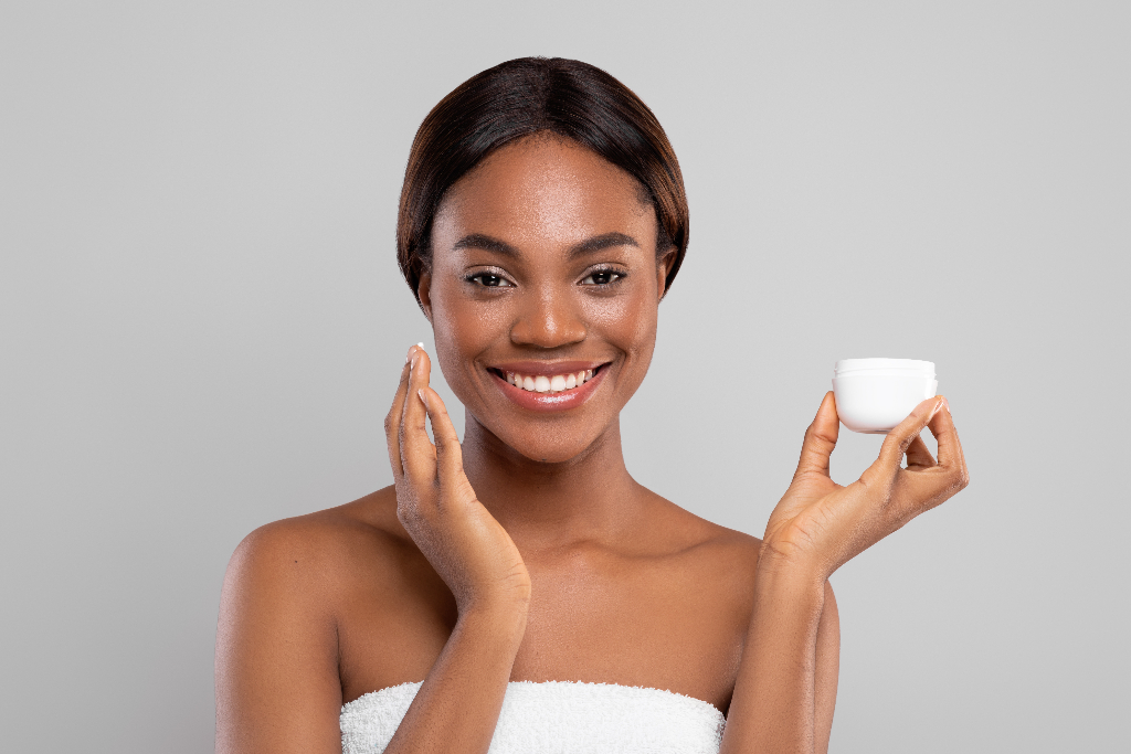 black woman holding a moisturizing cream