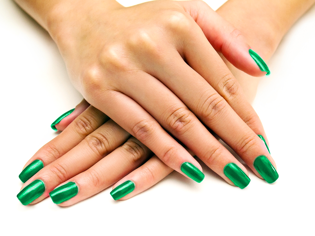 female hands with green manicure