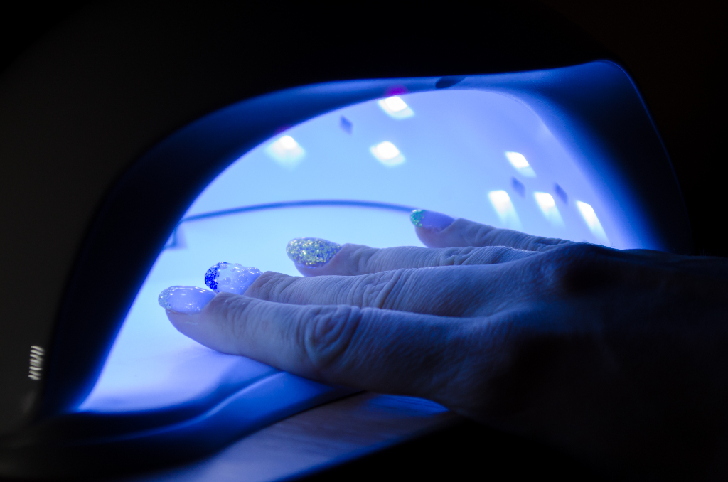 woman hand lies in an ultraviolet lamp