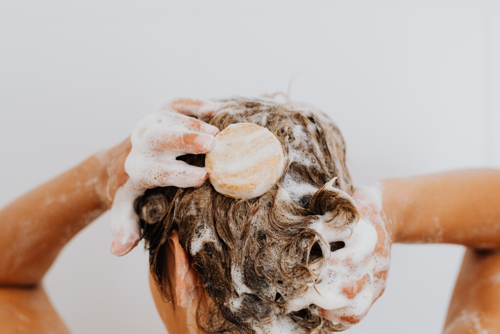 woman holding her hair with soap